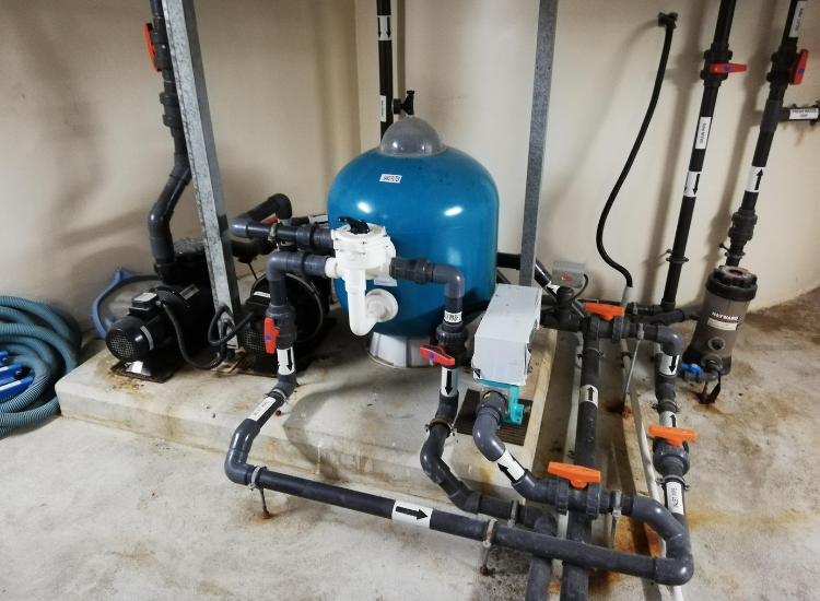 Water filtration tank with valves and pipes.
